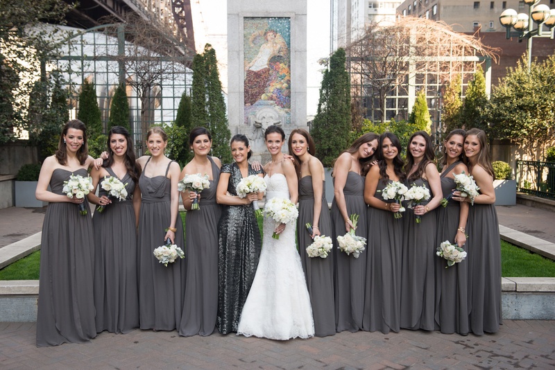 Bride with Bridesmaids in Grey Dresses
Photography: Ira Lippke Studios
Read More:
http://www.insideweddings.com/weddings/chic-classic-new-york-city-wedding-with-personal-touches/783/ a bride in a white lace wedding gown stands with her bridesmaids clad in gray gowns white bouquets
