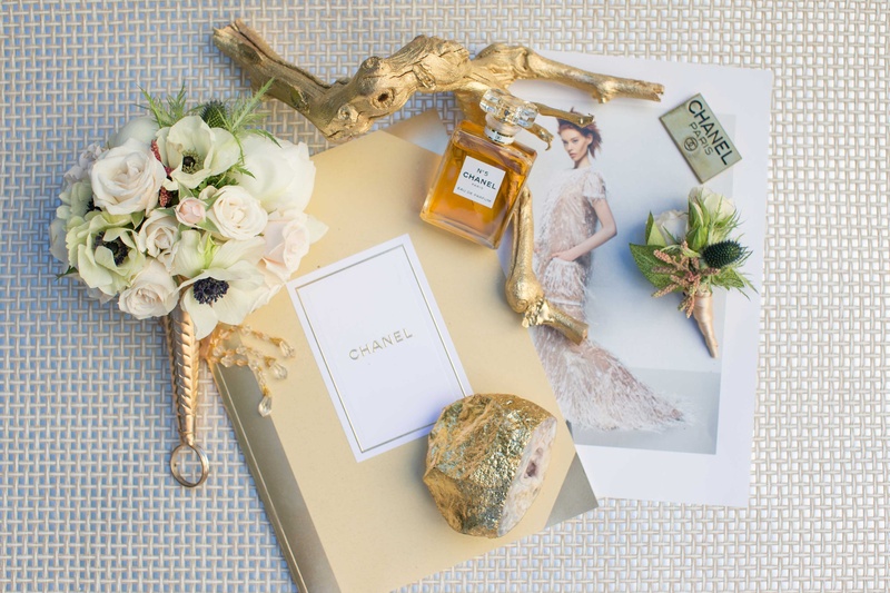 Assortment of Items Inspired by Coco Chanel
Photography: Thisbe Grace Photography
Read More:
http://www.insideweddings.com/weddings/dramatic-wedding-shoot-inspired-by-alexander-mcqueen-chanel/749/ small white and gold bouquet with coco chanel items journal picture perfume branch emblem