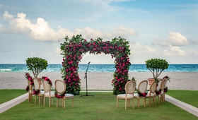 Intimate Wedding Ceremony by the Beach
Photography: Suzanne Delawar Studios
Read More:
http://www.insideweddings.com/weddings/intimate-oceanfront-wedding-with-romantic-red-pink-white-palette/1235/ wedding ceremony at acqualina resort and spa in florida greenery arch pink flowers chairs garlands