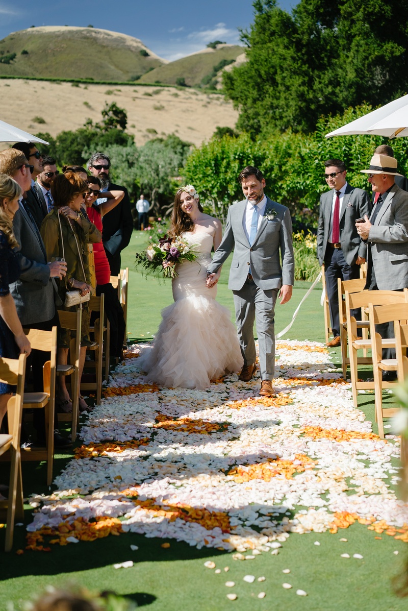 Bride and Groom Walk Down Aisle Together
Photography: Karlisch Photography
Read More:
http://www.insideweddings.com/weddings/modern-rustic-wedding-full-of-flowers-and-geometric-details/906/ bride in blush ruffled mermaid dress walks down the aisle with groom in grey suit and sky blue tie