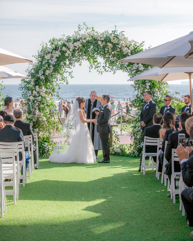 Lawn Ceremony by the Beach
Photography: Clane Gessel Photography
Read More:
http://www.insideweddings.com/weddings/ocean-view-ceremony-with-cultural-traditions-elegant-reception/1291/ wedding ceremony on grass lawn near beach ocean san diego coronado island umbrella greenery arch