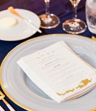White %26 Gold Menu on Charger Plate
Photography: Valorie Darling Photography
Read More:
http://www.insideweddings.com/weddings/santa-monica-wedding-with-tropical-touches-east-coast-inspiration/1232/ wedding menu card with gold calligraphy on white charger plate with gold rim matching flatware fork
