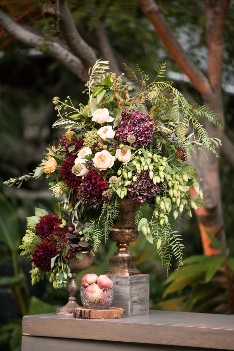 Fall Wedding Bar Floral Arrangement
Photography: Samuel Lippke Studios
Read More:
http://www.insideweddings.com/weddings/tuscany-meets-rustic-california-outdoor-wedding-under-the-stars/1336/ wedding reception wood bar with bowl of peaches and centerpiece with greenery burgundy flowers