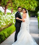 Couple Looks Over Shoulders in Pose
Photography: Paul Barnett Photographer
Read More:
http://www.insideweddings.com/weddings/bohemian-outdoor-garden-wedding-ceremony-rustic-reception/830/ a bride and groom turn back to camera outdoor space to smile holding each other Ines Di Santo dress