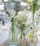 Wildflower Arrangements in Glass Vases on Rustic Table Runner
Photography: Willa Kveta Photography
Read More:
http://www.insideweddings.com/weddings/romantic-outdoor-bohemian-chic-wedding-at-a-santa-barbara-park/755/ white and green wildflower arrangements in glass vases on woven table runner white linens