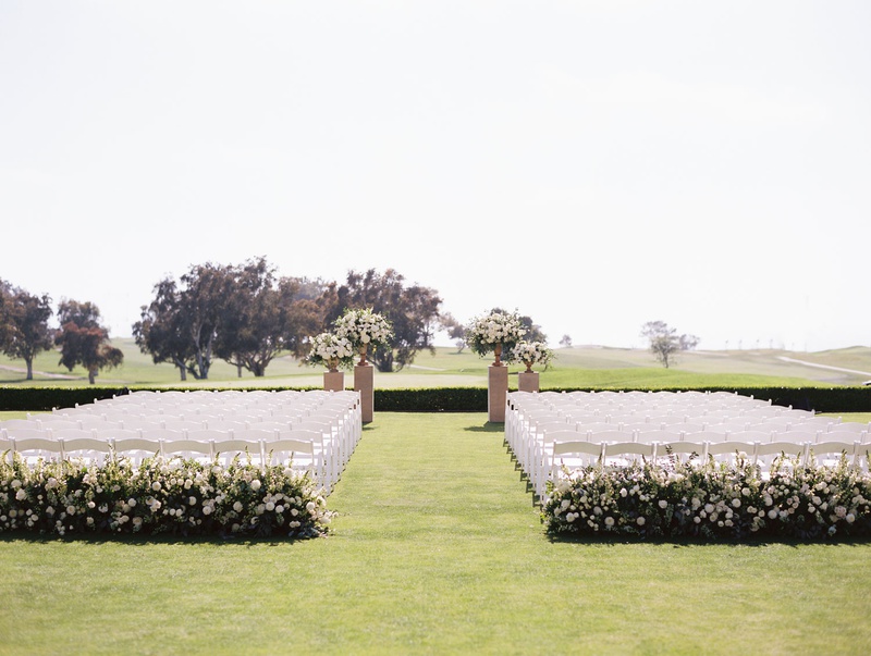 The Lodge at Torrey Pines Ceremony
Photography: Bryan Miller Photography
Read More:
http://www.insideweddings.com/weddings/romantic-spring-ceremony-reception-at-the-lodge-at-torrey-pines/1351/ wedding ceremony grass lawn golf course wedding hotel venue white chairs greenery flowers simple