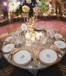 Reception Table
Photography: Images by Berit, Inc.
Read More:
http://www.insideweddings.com/weddings/opulent-summer-wedding-in-new-york-city/322/ Wedding reception table with gold-rimmed plates, golden napkins, candles, and flowers