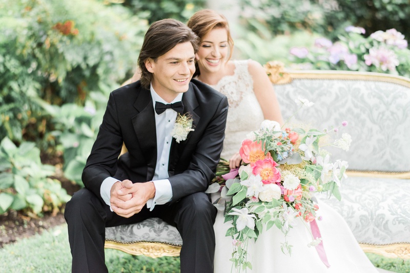 Victorian Era Styled Shoot Couple
Photography: Honey Honey Photography
Read More:
http://www.insideweddings.com/weddings/romantic-french-garden-decor-with-victorian-and-bohemian-style/832/ the bride and groom sit on a victorian inspired settee surrounded by bohemian inspired flowers