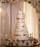 White %26 Gold Cake with Sugar Flowers
Photography: Lin %26 Jirsa Photography
Read More:
http://www.insideweddings.com/weddings/gorgeous-outdoor-ceremony-ballroom-reception-in-rancho-mirage/996/ Wedding cake on round table with gold ribbon details under flower arch ivory sugar flowers