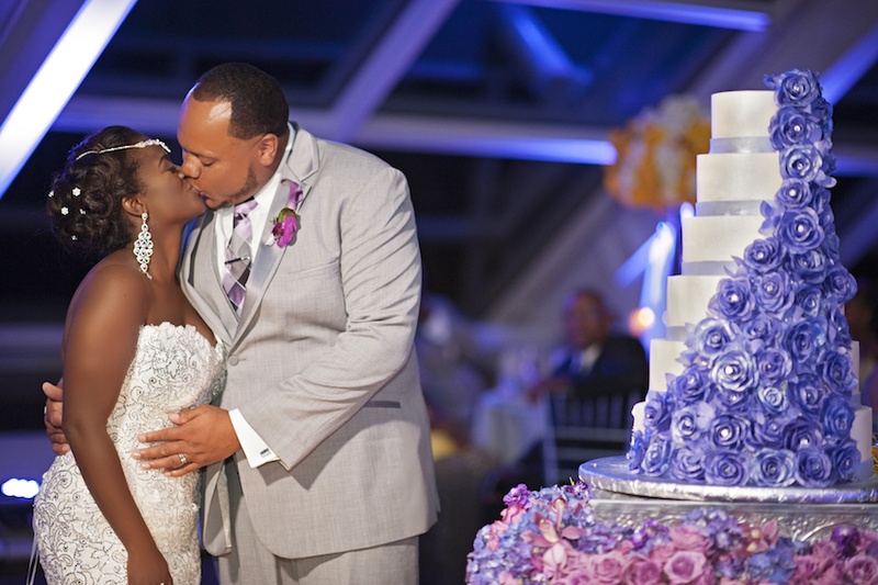Bride %26 Groom Kiss After Cake Cutting
Photography: Carasco Photography
Read More:
http://www.insideweddings.com/weddings/city-wedding-at-chicago-planetarium-with-purple-yellow-palette/688/ Bride in a spaghetti strap Pnina Tornai beaded dress kisses groom in grey suit, purple orchid