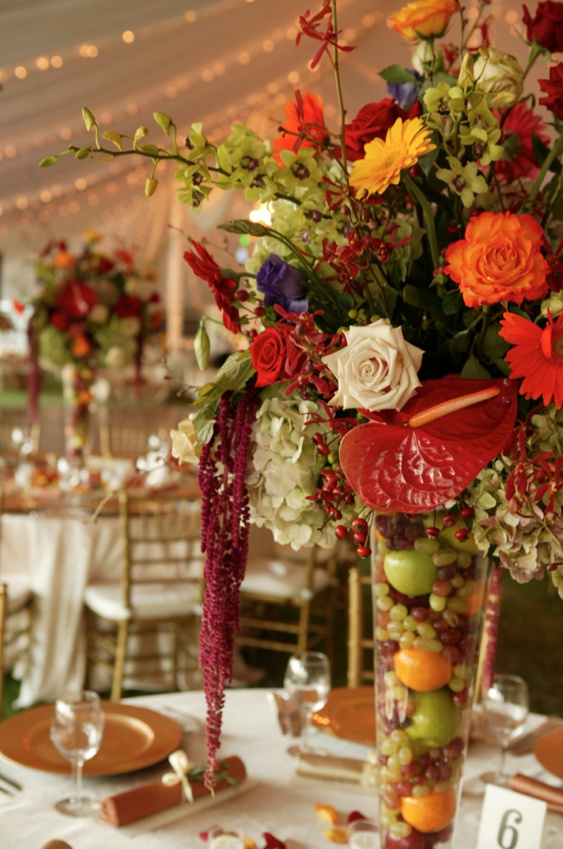 Tropical Fall Centerpiece
Photography: Mark Staff Photography
Read More:
http://www.insideweddings.com/weddings/autumn-inspired-golf-club-wedding-in-south-carolina/149/ Centerpiece with tropical flowers and fruit-filled vase
