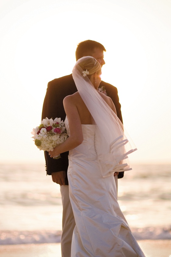 Sunset Beach Newlyweds
Photography: Mermin + Christie Photographers
Read More:
http://www.insideweddings.com/weddings/tropical-theme-beach-wedding-in-naples-florida/184/ bride and groom stand on sand at sunset