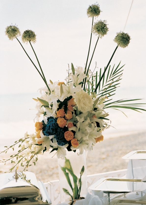 Buffet Table Decorations
Photography: Barnet Photography
Read More:
http://www.insideweddings.com/weddings/seaside-celebration-in-orange-county-california/32/ Floral arrangement on top of ice vase and buffet table