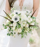 Bouquet with Feathers
Photography: Rachel Havel Photography
Read More:
http://www.insideweddings.com/weddings/unique-boho-chic-wedding-inspired-by-blue-agate-in-colorado/1362/ bouquet with anemone flowers, feathers, white flowers, and greenery