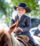 Ring Bearer on Horse with Cowboy Hat
Photography: Mark Steines
Read More:
http://www.insideweddings.com/weddings/western-wedding-with-rustic-decor-at-the-oldest-barn-in-iowa/705/ Young ring bearer boy riding Western saddle horse