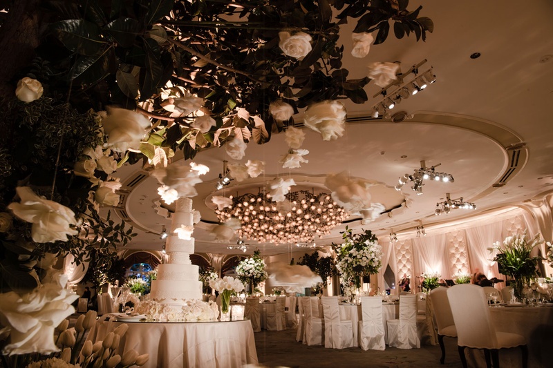 Ivory Wedding Décor with Greenery
Photography: John Solano Photography
Read More:
http://www.insideweddings.com/weddings/an-opulent-garden-ceremony-ballroom-reception-in-beverly-hills/986/ Ballroom wedding with chair covers tall wedding cake fresh greenery ivory flowers suspended