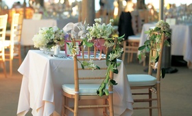 Floral-Embellished Chairs
Photography: Christofer Jae Photography
Read More:
http://www.insideweddings.com/weddings/asian-inspired-oceanfront-wedding-in-big-sur-california/110/ Wood chair with greenery and flowers on back
