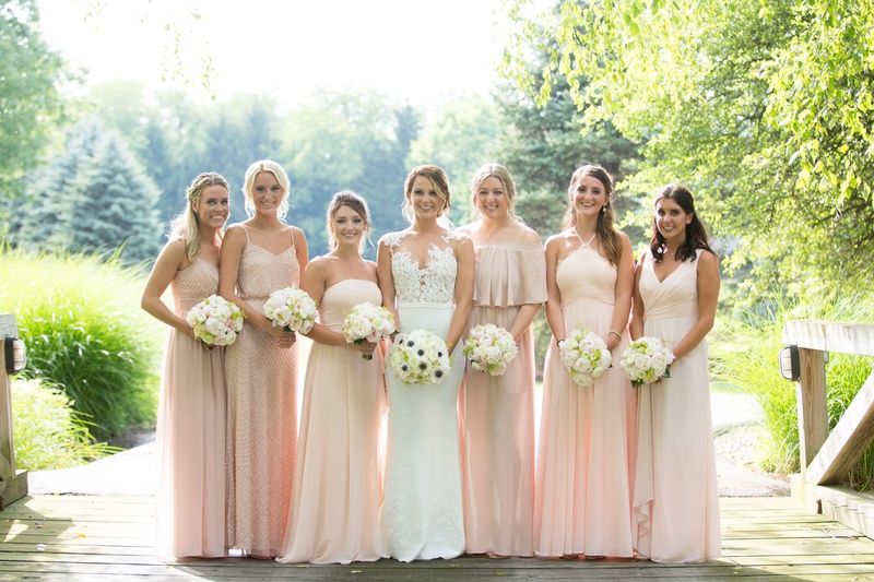 Bride and Bridesmaids on the Bridge
Photography: Little Tree Studios
Read More:
http://www.insideweddings.com/weddings/brian-winters-of-the-new-york-jets-romantic-rustic-chic-wedding/1245/ bride in pronovias gown with illusion neckline lace bodice, mismatched bridesmaids in blush