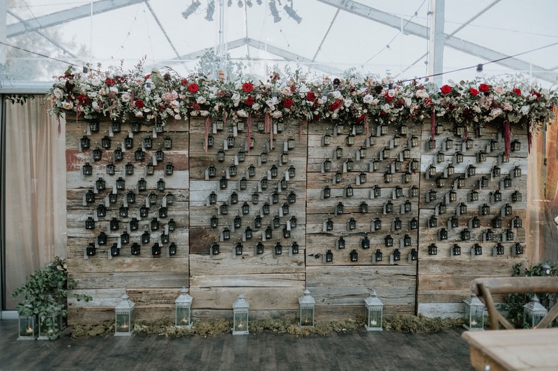 Reclaimed Wood Escort Card Display
Photography: Grant Daniels Photography
Read More:
http://www.insideweddings.com/weddings/outdoor-ceremony-tented-reception-with-cozy-fall-color-palette/1183/ wedding reception fall wedding ideas lanterns reclaimed wood wall burgundy flowers