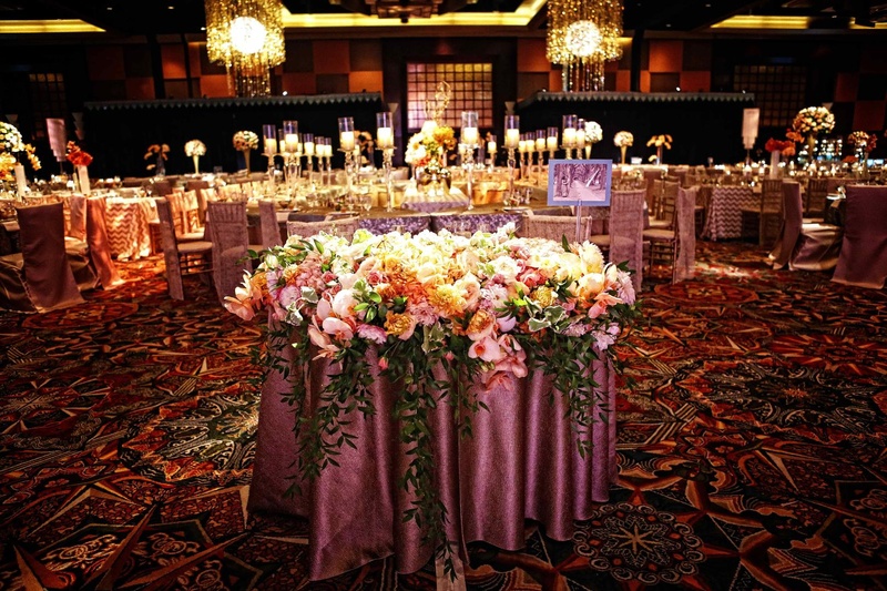 Floral Décor
Photography: Tomas Ramos Photographers
Read More:
http://www.insideweddings.com/weddings/houston-indian-wedding-celebration-with-800-person-guest-list/435/ Wedding reception with a decorative table draped in a rosy tablecloth and covered with flowers