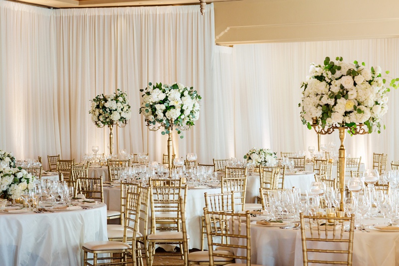 Classic White Wedding Reception
Photography: Chard Photo
Read More:
http://www.insideweddings.com/weddings/alfresco-ceremony-on-the-coast-classic-ballroom-reception/1290/ the resort at pelican hill wedding reception with gold chiavari chairs, tall white centerpieces