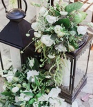 Lanterns with Verdant Florals at Ceremony
Photography: This Modern Romance
Read More:
http://www.insideweddings.com/weddings/rustic-chic-wedding-with-wooden-accents-and-verdant-details/861/ black lanterns at front of ceremony with white flowers and greenery