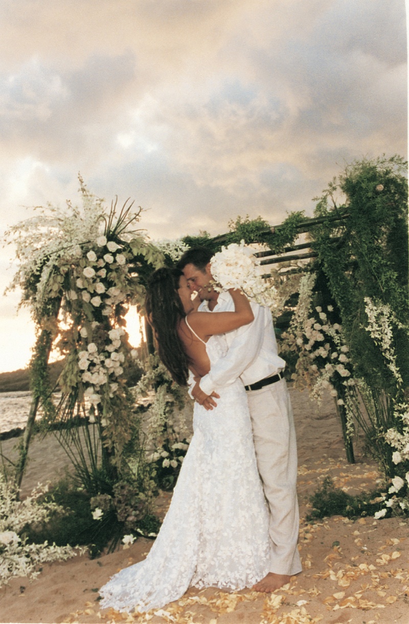 Newlyweds Kiss at Wedding Chuppah
Photography: David Michael Photography
Read More:
http://www.insideweddings.com/weddings/tropical-seaside-wedding-in-lanai-hawaii/60/ bride and groom kiss in front of chuppah decorated with greenery and white flowers