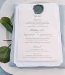 Wax Seal on Menu
Photography: Nicole Barr Photography
Read More:
http://www.insideweddings.com/weddings/ceremony-overlooking-the-bay-tented-reception-at-beach-house/1295/ blue-grey napkin and linens, grey wax seal on menu