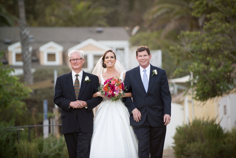 Fathers of the Bride
Photography: Strand Photo
Read More:
http://www.insideweddings.com/weddings/vibrantly-hued-catalina-island-wedding-inspired-by-the-ocean/941/ bride walks down aisle with father and stepfather at beach wedding