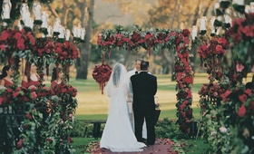 Red Rose Ceremony
Photography: Miki and Sonja Photography
Read More:
http://www.insideweddings.com/weddings/a-passionate-golf-club-wedding-inspired-by-red-roses/72/ Bride and groom at outdoor red rose ceremony