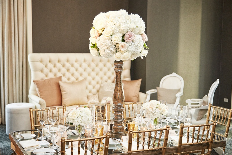 Reception Table in Front of Seating Area
Photography: KingenSmith
Read More:
http://www.insideweddings.com/weddings/catholic-ceremony-soft-romantic-fairy-tale-reception-in-chicago/754/ tall rose centerpiece with high base on table with gold chiavari chairs