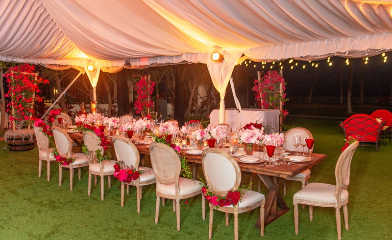 Romantic Intimate Tented Wedding
Photography: Suzanne Delawar Studios
Read More:
http://www.insideweddings.com/weddings/intimate-oceanfront-wedding-with-romantic-red-pink-white-palette/1235/ wedding reception wood table chairs pink red rose garlands low centerpiece red glassware
