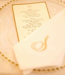 Gold Place Setting
Photography: Donna Newman Photography
Read More:
http://www.insideweddings.com/weddings/elegant-all-white-wedding-at-the-breakers-in-florida/362/ Gold bead charger plate with gold menu and monogram napkin