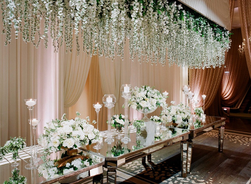 Glamorous Mirrored Escort Card Table
Photography: Jose Villa Photography
Read More:
http://www.insideweddings.com/weddings/glamorous-sophisticated-garden-themed-ballroom-wedding-in-chicago/905/ Mirror table with white flower and greenery installation over table, white rose escort card table