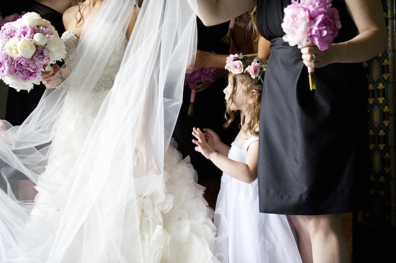 Observant Flower Girl
Photography: Images by Berit, Inc.
Read More:
http://www.insideweddings.com/weddings/wedding-with-purple-modern-details-at-a-chateau-in-new-jersey/693/ Flower girl in white dress with thick straps and pink rose crown looks at bride in strapless Lazaro