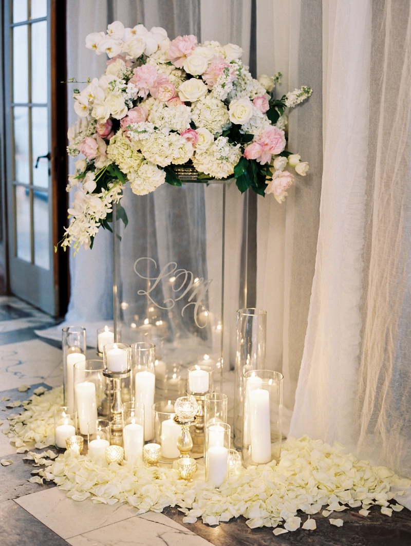 Monogrammed Clear Riser at Ceremony
Photography: Abby Jiu Photography
Read More:
http://www.insideweddings.com/weddings/chic-parisian-romance-inspired-spring-wedding-in-washington-dc/1038/ Wedding ceremony grouping of candles around clear riser with white and pink flowers on top flowers