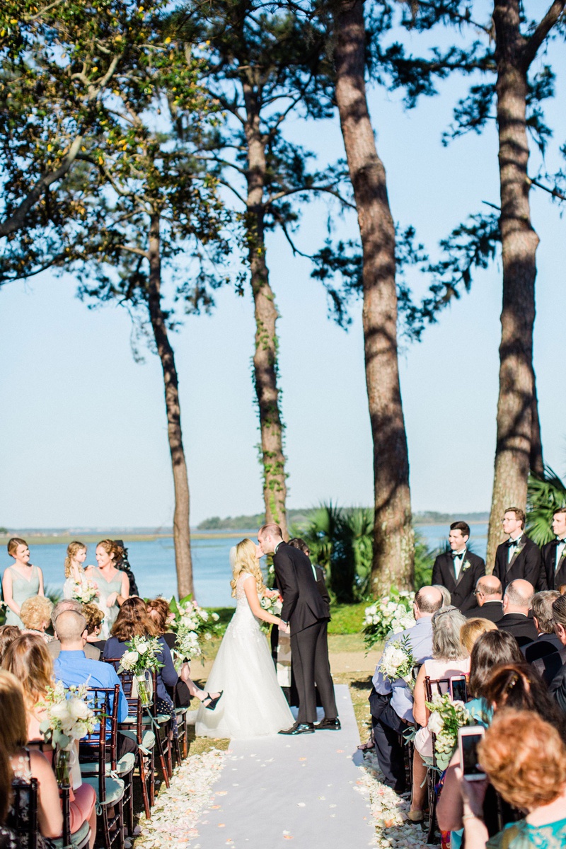 Alfresco South Carolina Wedding
Photography: Vitor Lindo Photo + Video
Read More:
http://www.insideweddings.com/weddings/soft-romantic-spring-destination-wedding-in-south-carolina/1285/ bride and groom kiss during outdoor wedding ceremony montage palmetto bluff water view flower petals
