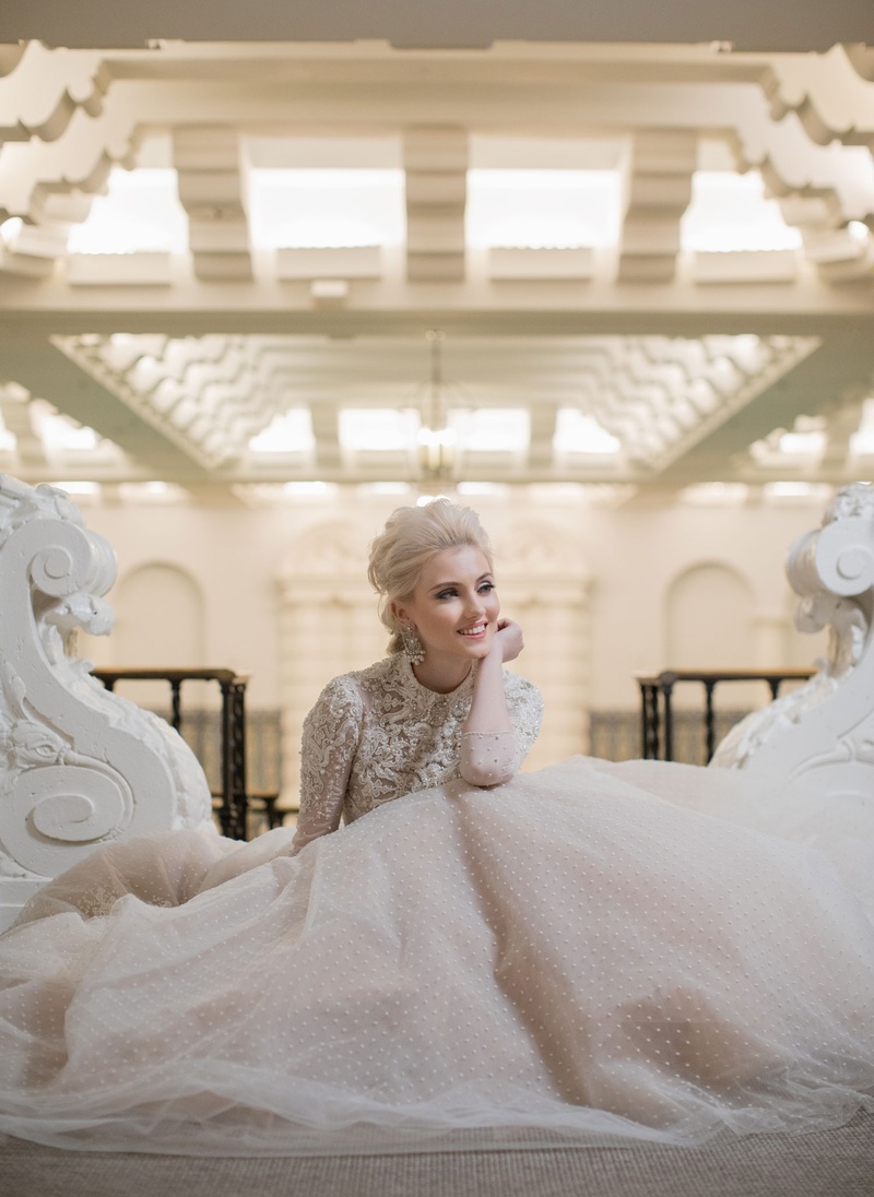 Wintry Long-Sleeve Wedding Dress
Photography: Collin Pierson Photography
Read More:
http://www.insideweddings.com/weddings/winter-wedding-inspirational-shoot-with-opulent-frosted-decor/1108/ Bride sitting down in long sleeve ball gown point d'esprit skirt embellished bodice long sleeves