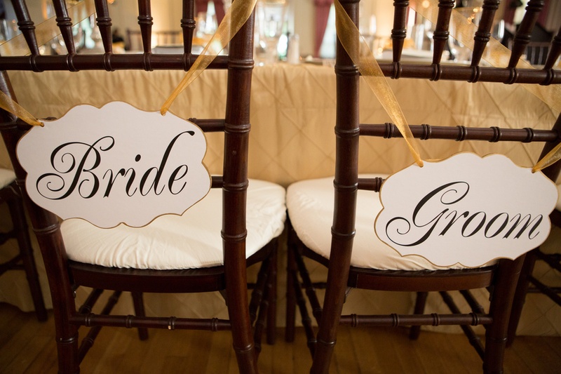 Bride %26 Groom Chairs
Photography: Aaron Watson Photography
Read More:
http://www.insideweddings.com/weddings/classic-virginia-wedding-inspired-by-grace-kellys-elegance/511/ Die-cut signs tied to reception chairs with gold ribbon