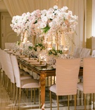 Rose %26 Dendrobium Orchid Centerpiece
Photography: Samuel Lippke Studios
Read More:
http://www.insideweddings.com/weddings/outdoor-jewish-wedding-ceremony-glam-reception-in-beverly-hills/848/ Mirror top wedding reception table with white chameleon chairs ruched and white pink centerpieces