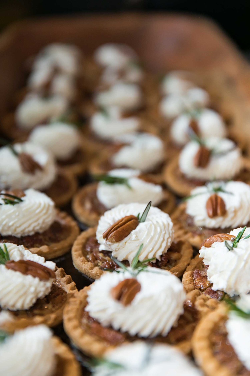 Miniature Pecan Pie Desserts
Photography: Vue Photography
Read More:
http://www.insideweddings.com/weddings/destination-rustic-fall-wedding-at-a-farm-in-north-carolina/1202/ wedding desserts miniature pecan pie with pecan on top whipped cream