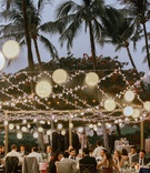Guests at Outdoor Hawaii Wedding
Photography: Chris J. Evans Photography
Read More:
http://www.insideweddings.com/weddings/outdoor-winter-ceremony-and-reception-on-the-big-island-in-hawaii/1306/ wedding reception outside palm trees string lights gold chameleon chair collection seats dusk shot
