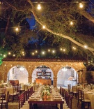 Warm Alfresco Reception at Ranch
Photography: Apertura
Read More:
http://www.insideweddings.com/weddings/warm-inviting-outdoor-fall-wedding-with-romantic-rustic-details/1363/ wedding reception long wood table short centerpiece bistro lights hanging from trees ranch courtyard