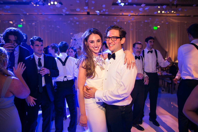Bride in Second Dress for Dancing
Photography: Samuel Lippke Studios
Read More:
http://www.insideweddings.com/weddings/romantic-jewish-wedding-with-lush-ivory-flowers-rose-gold-details/790/ Wedding reception purple pink lighting bride in second wedding dress groom in white shirt bow tie