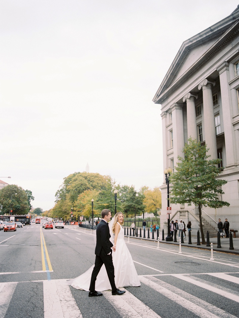 Couple on DC Street
Photography: Abby Jiu Photography
Read More:
http://www.insideweddings.com/weddings/modern-wedding-with-a-black-and-white-palette-in-washington-dc/1236/ bride in romona keveza a-line gown plunging neckline with groom crossing DC street