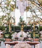 Opulent Sweetheart Table
Photography: Binaryflips Photography
Read More:
http://www.insideweddings.com/weddings/bayfront-ceremony-garden-courtyard-reception-in-sarasota-florida/1344/ sweetheart table with carved bench, three tall gold candelabra with greenery, chandelier above