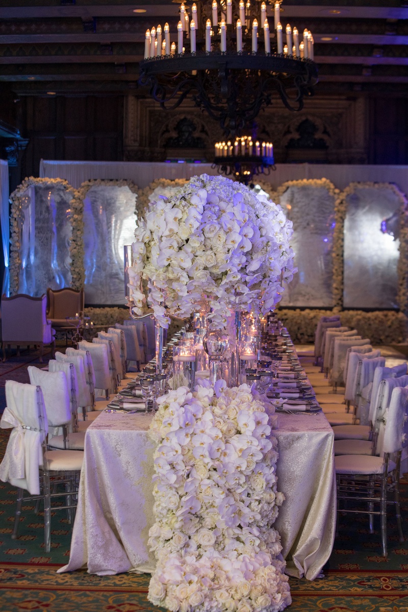 Long Table with Floral "Runner"
Photography: Collin Pierson Photography
Read More:
http://www.insideweddings.com/weddings/winter-wedding-inspirational-shoot-with-opulent-frosted-decor/1108/ Wedding reception white chair cover linen with thick flower runner that matches centerpieces