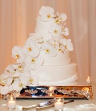 All-White Wedding Cake
Photography: Marisa Holmes
Read More:
http://www.insideweddings.com/weddings/seafoam-ivory-hued-oceanfront-wedding-in-laguna-beach-california/431/ Four layer cake decorated with cascading orchids