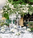 Elegant Centerpieces
Photography: Thanos Asfis Photography
Read More:
http://www.insideweddings.com/weddings/four-day-destination-wedding-celebration-on-island-in-greece/1299/ outdoor wedding reception with silver candelabra, white roses, black chairs