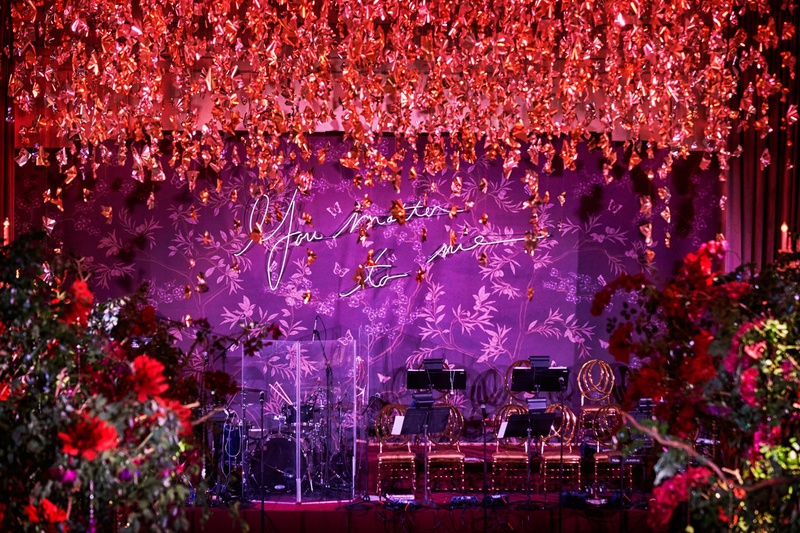 "You Matter To Me" Neon Sign
Photography: KingenSmith
Read More:
http://www.insideweddings.com/weddings/luxurious-wedding-featuring-sentimental-butterfly-decor-in-chicago/1348/ purple neon sign you matter to me red flowers hanging from ceiling over dance floor live band stage
